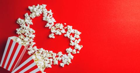 Spilled popcorn forming a heart on a red background