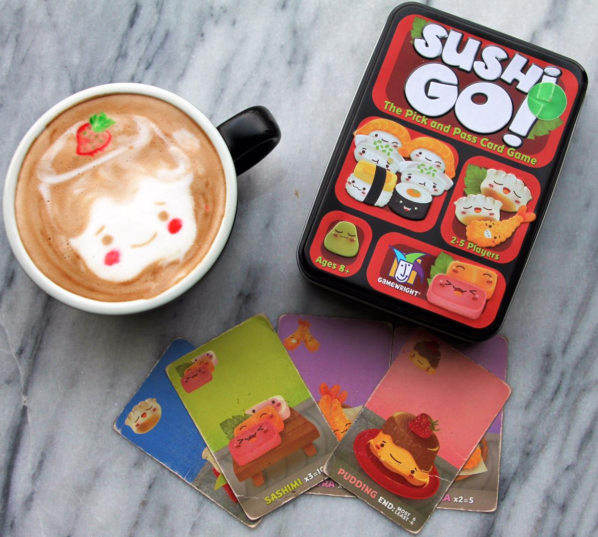 Cup of hot chocolate with Sushi Go game